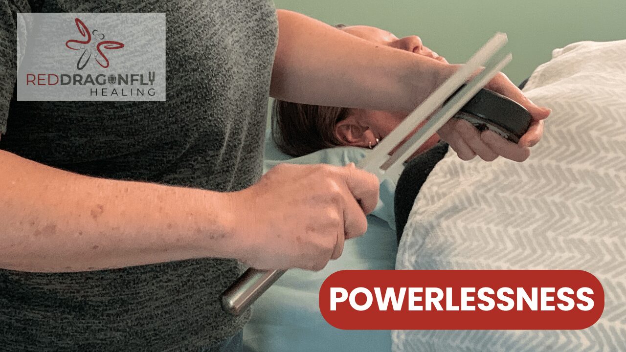 A person uses tuning forks near another person lying on a bed, suggesting a healing session. The text reads RED DRAGONFLY HEALING and POWERLESSNESS.